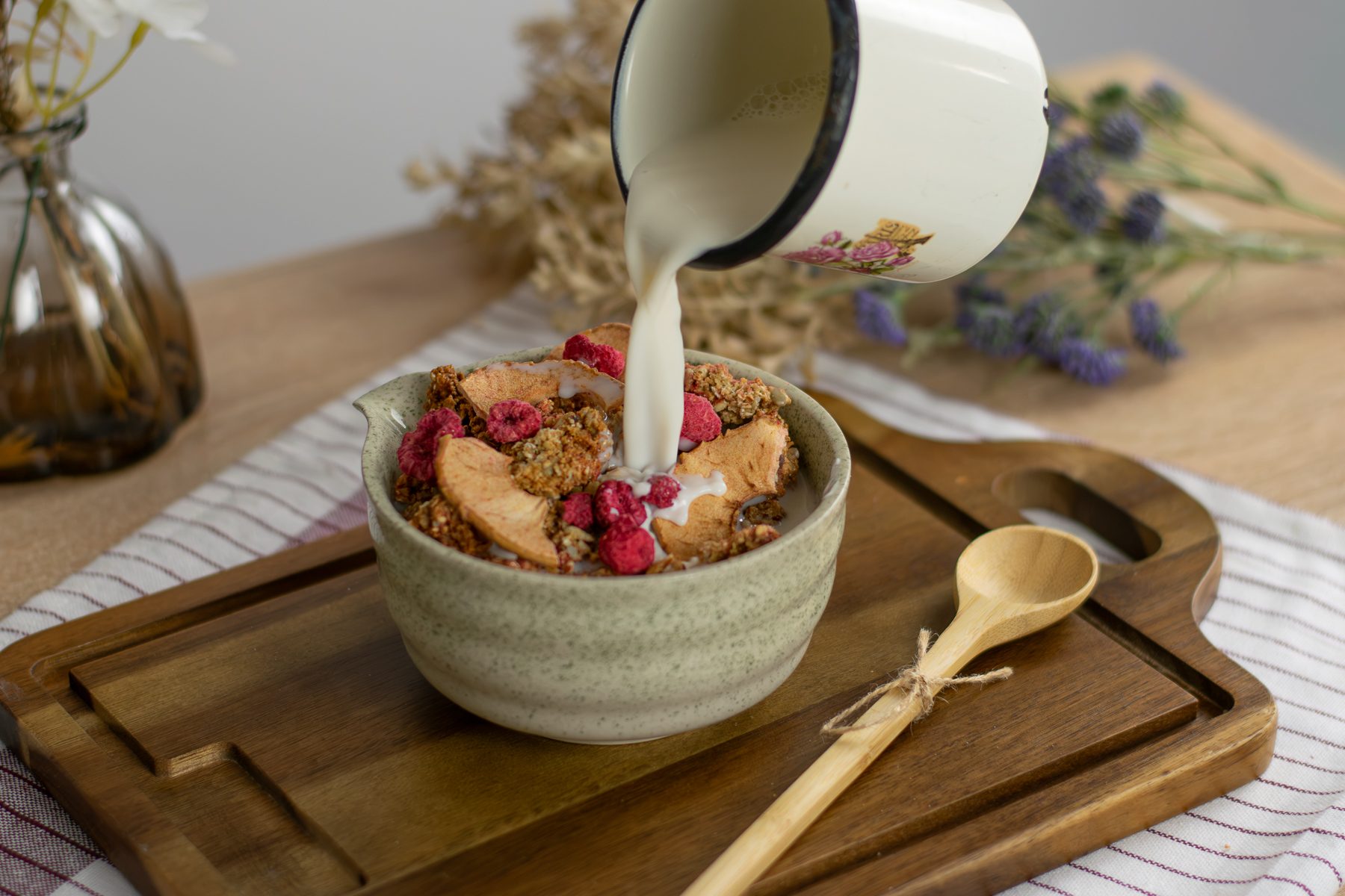Malinová granola v miske, zalievaná mliekom